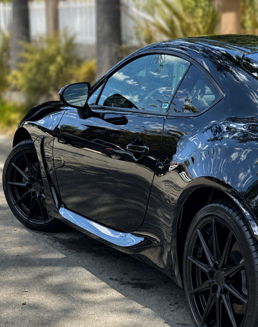 Profile of a black Subaru BRZ with deep paint reflections after paint enhancement